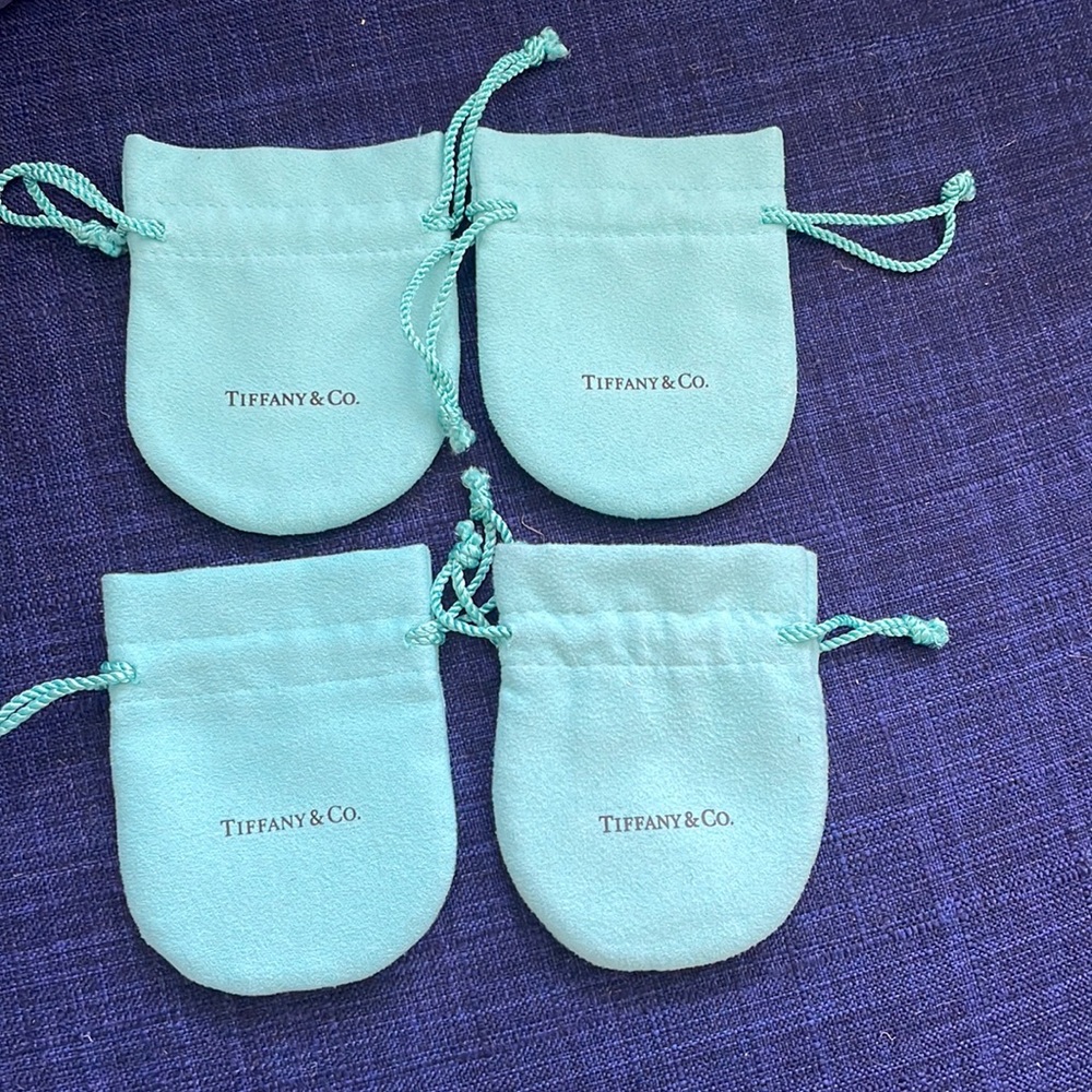 Four Tiffany jewelry pouches in perfect condition.